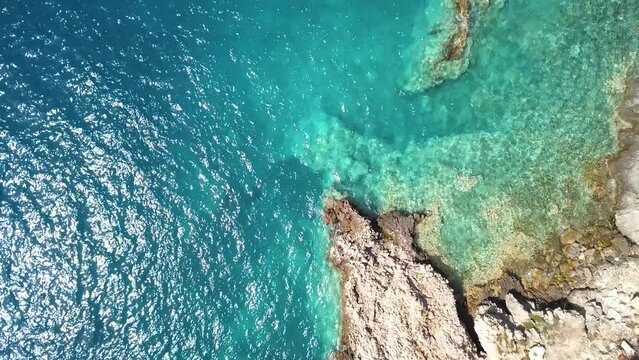 Italy, July 2022: Aerial view in 4K of the Tremiti islands in Puglia with n Caribbean sea, cliffs and boats off the coast