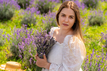 Attractive brunette woman clasping a bunch of lavender