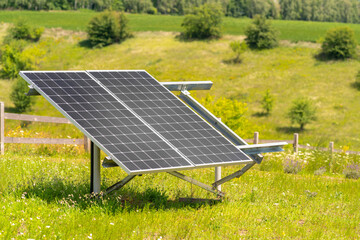 Two solar panels mounted in a frame in a farm field