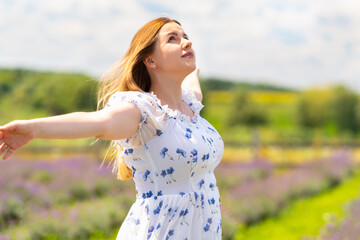 Joyful young woman rejoicing with outstretched arms