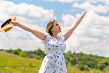 Carefree joyful woman celebratjng with outstretched arms