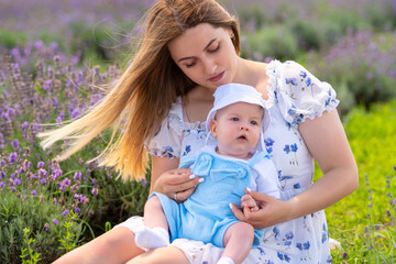 Young mother enjoying a summer day outdoors with her baby