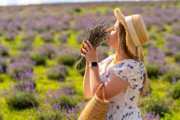 Young womqn savouring the fragrance of fresh lavender