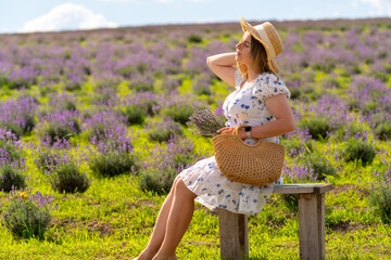 Young woman enjoying the sumner sunshine in lavender fields