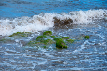 Detail of the sea waves reaching the beach.