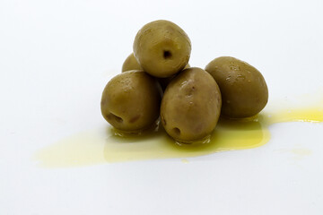 olives with oil on white background (aceitunas)