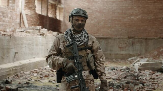 Soldier in full uniform posing inside of destroyed building. High quality 4k footage