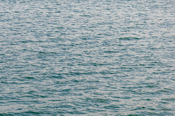Obraz premium Blue turquoise transparent water surface of a sea with small waves