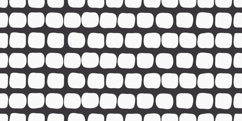 
White uneven pads on a black background. Decorative pattern seamless and stylish of white rounded shapes.