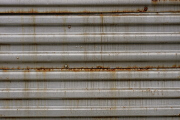 metal texture of an old gray striped iron wall in brown rust