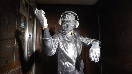 Sparkle masked man dancing in a lift