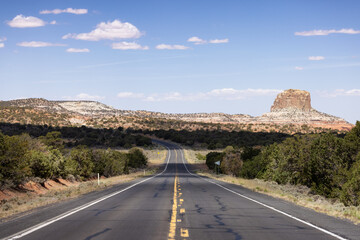 Scenic Road in the Dry Desert with Red Rocky Mountains in Background. Arizona, United States.
