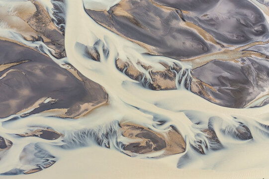 Aerial view of a water abstract pattern from a river estuary in Iceland.