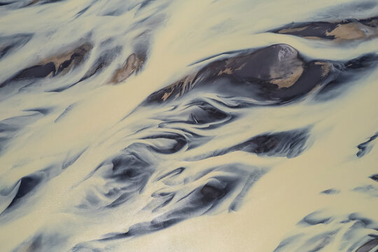 Aerial view of a water abstract pattern from a river estuary in Iceland.