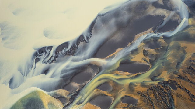 Aerial view of a water abstract pattern from a river estuary in Iceland.