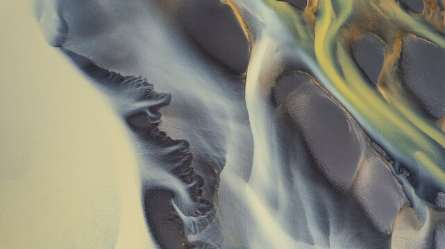 Aerial view of a water abstract pattern from a river estuary in Iceland.