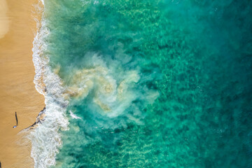 Aerial view of a person on the beach at Playa de los Amantes, Cabo San Lucas, Baja California, Mexico.