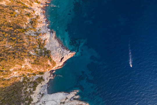 Aerial view of a boat sailing near Capo d'Enfola, Portoferraio, Elba Island, Tuscany, Italy.