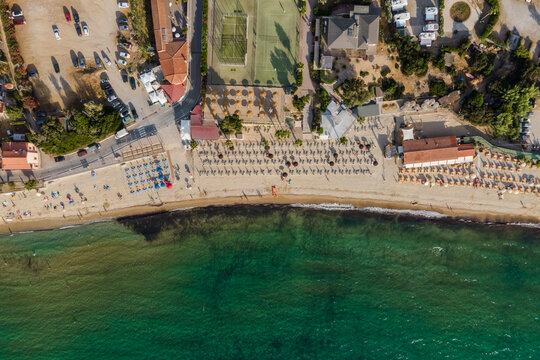 Aerial view of a small beach along the coast with parasols in summertime, Procchio, Elba Island, Italy.