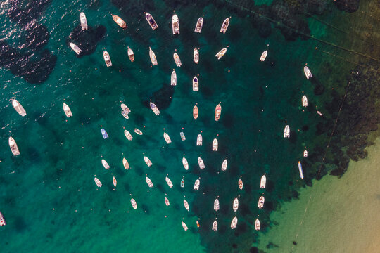 Aerial view of sailing and fishing boats docked in a small bay in Procchio near Marciana Marina, Elba Island, Italy.