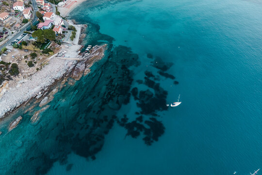 Aerial view of a sailing boat along the coast in Seccheto, Elba Island, Tuscany, Italy.