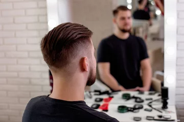 Gordijnen Brunette man with stylish haircut on barbershop background © Galina