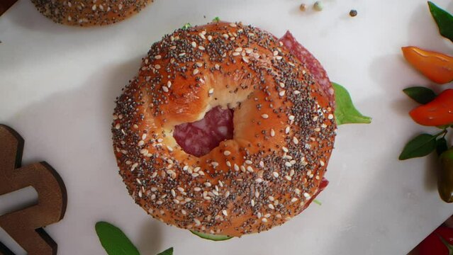 Video of the top of the bagel falls in slow motion, flat lay tabletop food cooking
