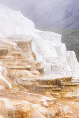 Fototapeta na wymiar Hot Spring Landscape with colorful ground formation. Mammoth Hot Springs, Yellowstone National Park, Wyoming, United States. Nature Background.