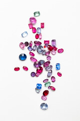 Synthetic Stones for jewellery making. Faceted colorful glass rhinestones on White - obrazy, fototapety, plakaty