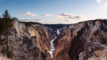 Rocky Canyon, River and Waterfall in American Landscape. Grand Canyon of The Yellowstone. Cloudy Sky Art Render. Yellowstone National Park. United States. Nature Background.