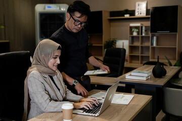 Fototapeta na wymiar Muslim business man and woman, busy with documents and laptop in modern office, business concept