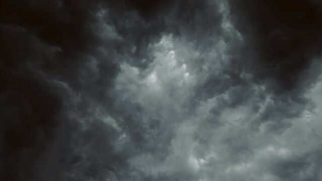 Rainy sky. Bad weather. Aerial view. Thundery dark gray fluffy clouds covering heaven flying through slow motion.