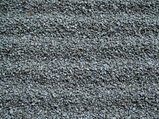 Small rubble. Background of gray rubble. Coarse gray sand.