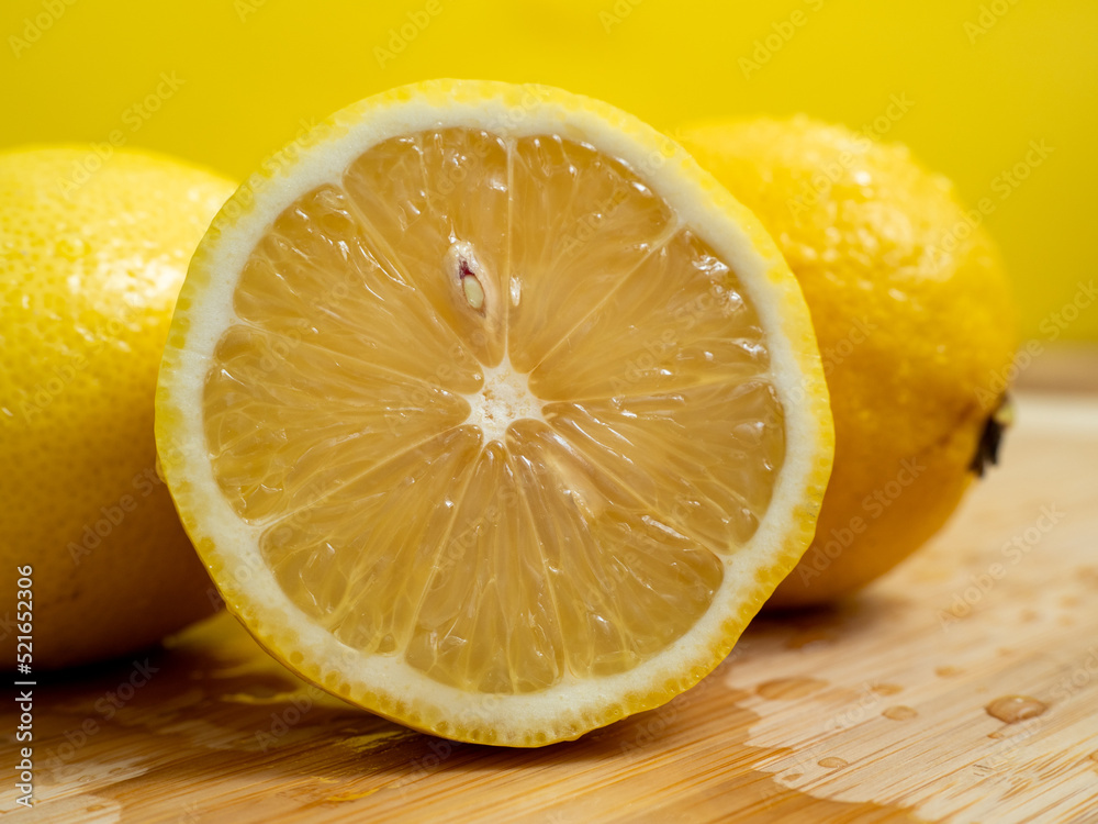 Wall mural ripe lemon on a wooden board. fresh lemons on a wooden background.