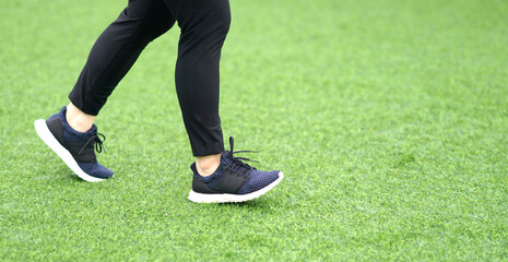 woman wearing sports shoes jogging run in the lawn