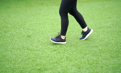 woman wearing sports shoes jogging run in the lawn