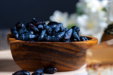 honeysuckle berries in a wooden plate