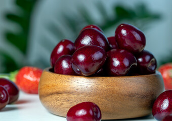 sweet berries of ripe red cherries during meals