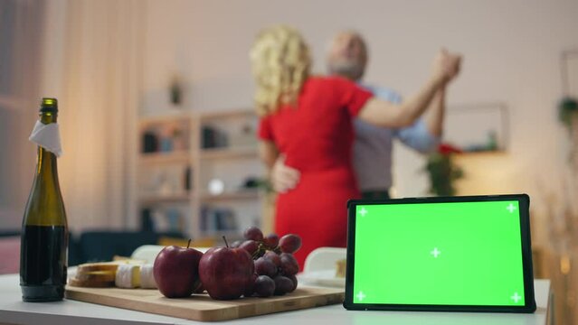 Tablet With Green Screen On Table, Couple Dancing On Background, Online Dating