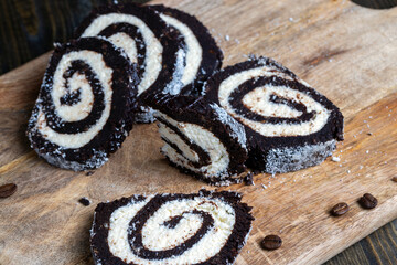 chocolate roll with a creamy curd layer in coconut chips
