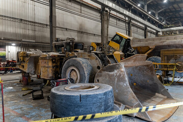 Repair of an underground loading machine in an industrial garage.