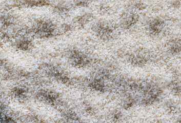 a pile of scattered white rice on the kitchen table