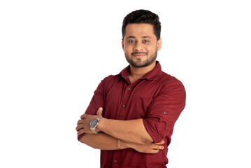 Portrait of a happy young man posing with arms crossed or hands folded on a white background