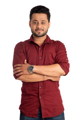 Portrait of a happy young man posing with arms crossed or hands folded on a white background