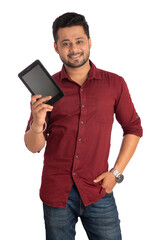 Young handsome man, businessman showing a blank screen of a smartphone or mobile or tablet phone on white background