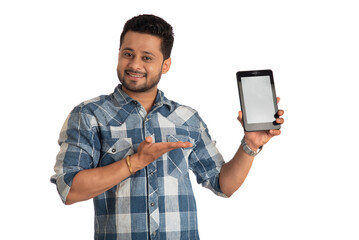 Young handsome man, businessman showing a blank screen of a smartphone or mobile or tablet phone on white background