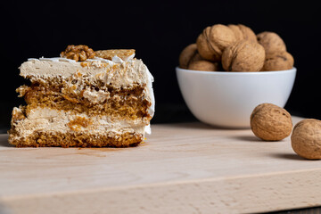 a piece of cake with buttercream and walnuts