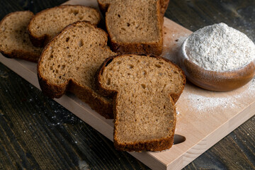 sliced rye bread on a wooden table, close up