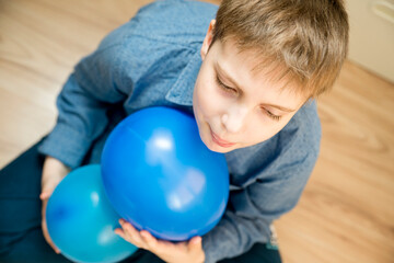 Fototapeta na wymiar Global autism day commemoration theme. Boy with a blue balloon.