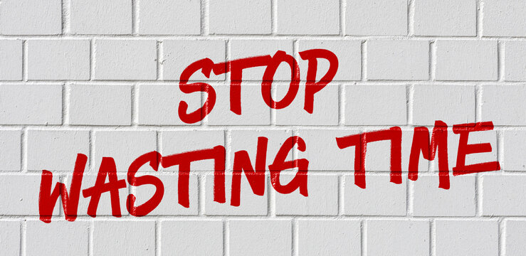  Graffiti on a brick wall - Stop wasting time